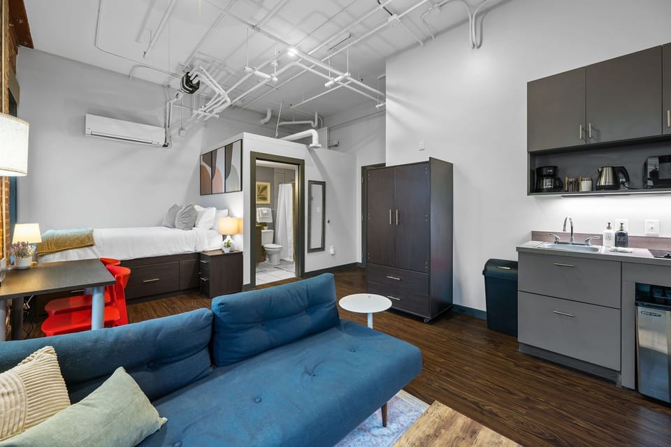 Modern open-concept space with stylish furnishings and entertainment setup.