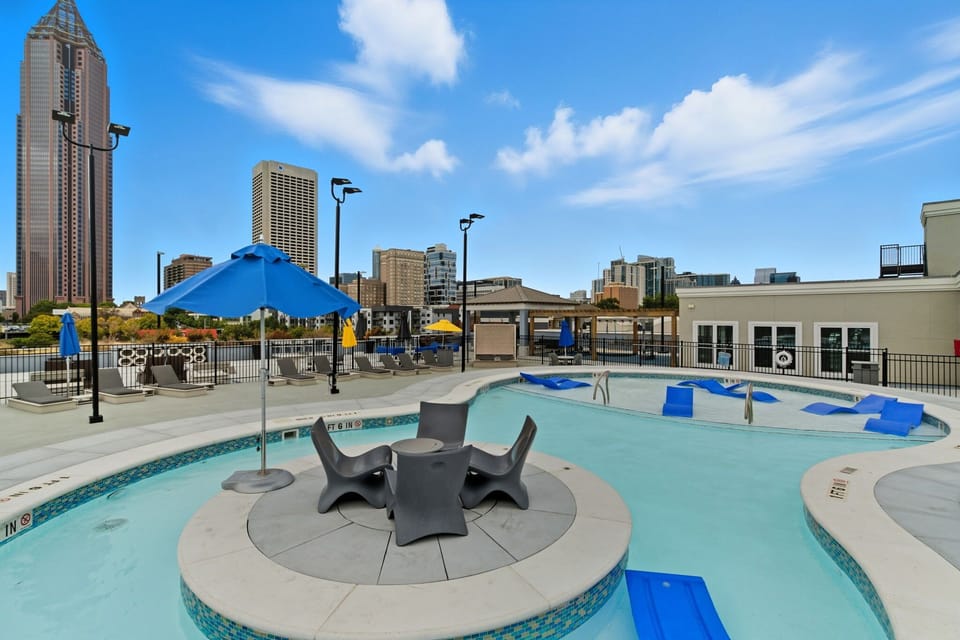 Resort-style pool with lounge chairs and skyline views — experience luxury without leaving your building.
