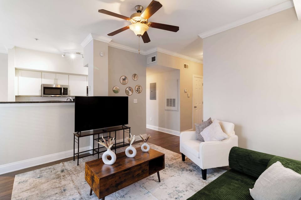 Spacious open-concept living room with smart TV for entertainment & comfort.