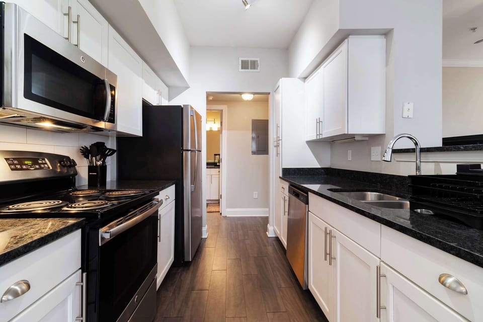 Fully equipped kitchen with stainless steel appliances — perfect for home-cooked meals.