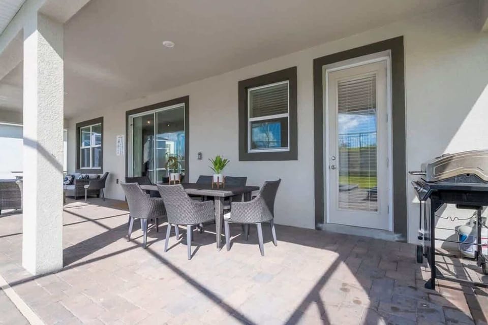 Elegant outdoor dining area with a modern table, comfortable chairs, and a stylish centerpiece, perfect for alfresco meals.