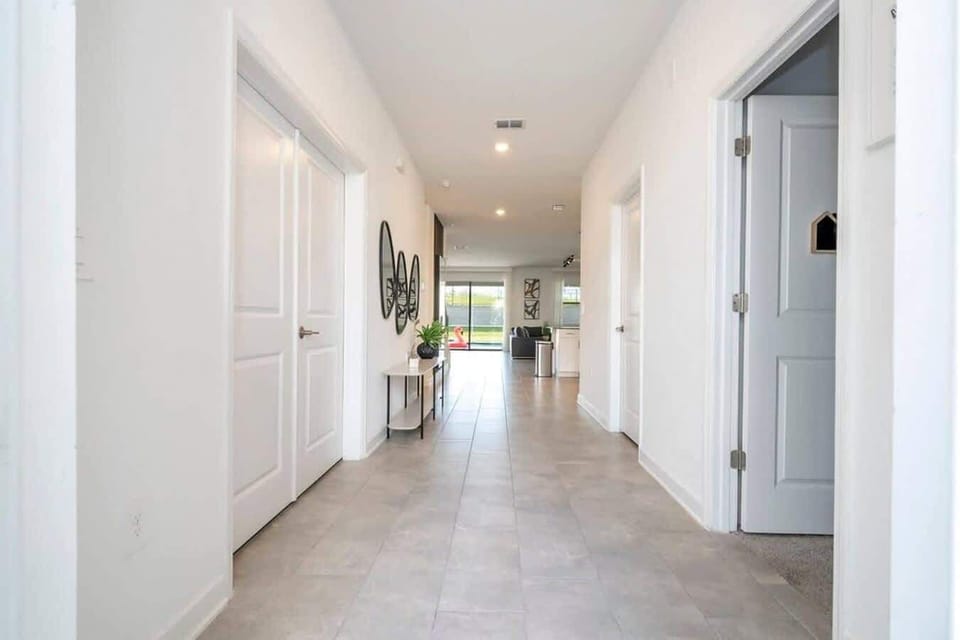 Bright, welcoming hallway leading to the open living area and pool views-plenty of space for everyone to come and go with ease.