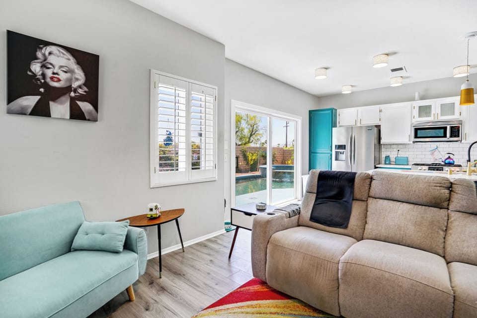 Living area with fireplace, smart TV & patio pool views
