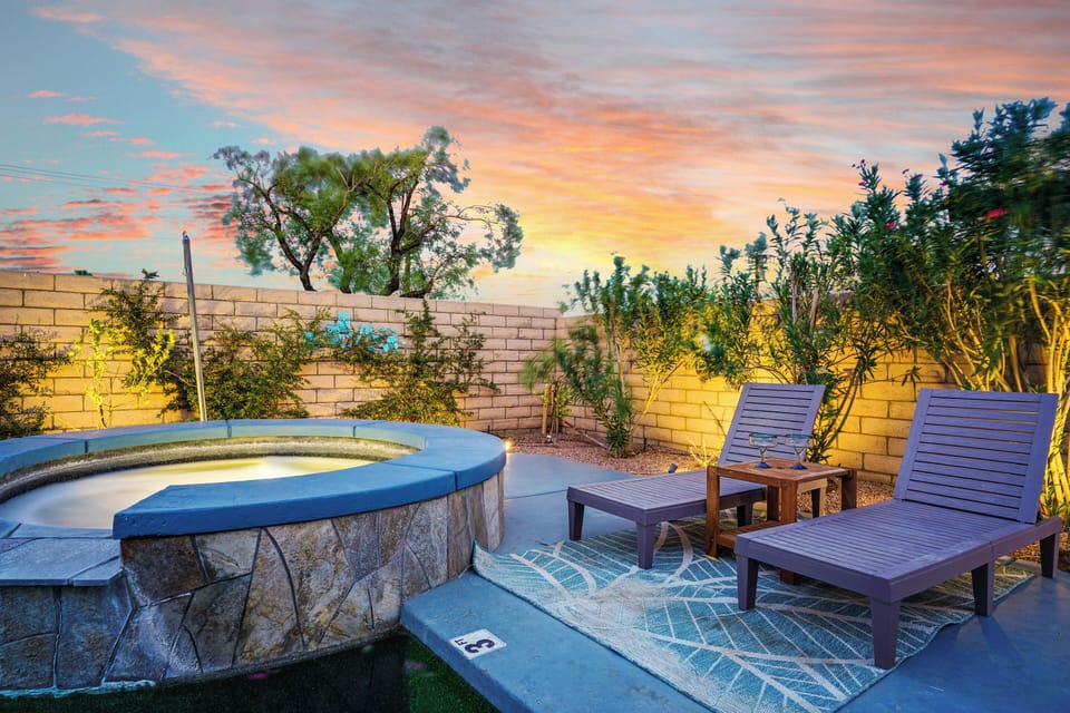 Heated spa with lounge chairs & mountain sunset views