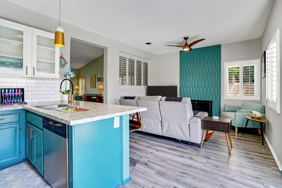 Open-concept kitchen flows into stylish midcentury living room