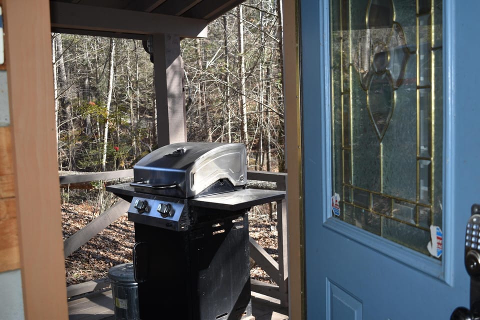 Propane grill on front porch close to kitchen