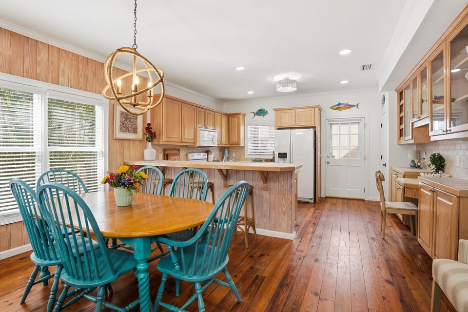 Kitchen with Breakfast Bar and Dining Area - Open kitchen with natural wood cabinetry, wraparound counters, breakfast bar, and an easy connection to the dining area.