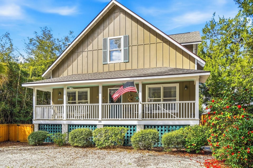 Covered Front Porch on Ocean View - Classic St. Simons cottage with a deep covered front porch and elevated design. A short walk toward the King and Prince area and the beach beyond.