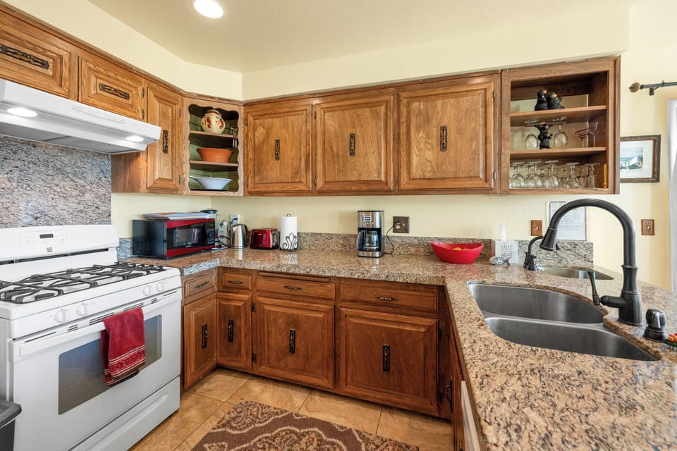 Full Kitchen - The fully stocked kitchen includes granite countertops, full-size appliances, cookware, and a coffee maker.