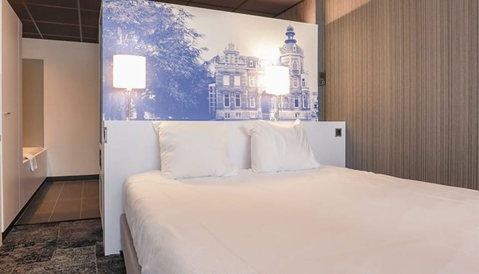 Drift off in crisp linens beneath a striking feature wall.