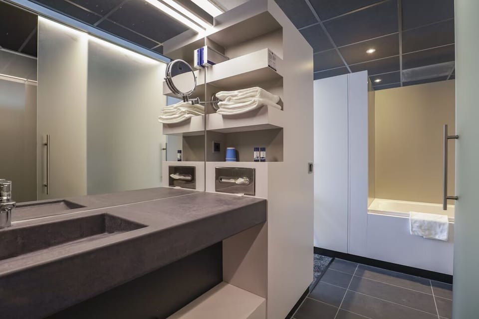 Refresh in a spacious bath with bright lighting and plush towels.