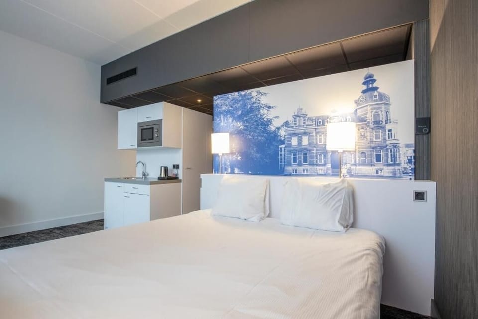 Unwind in a bright studio bedroom with sleek kitchenette convenience.