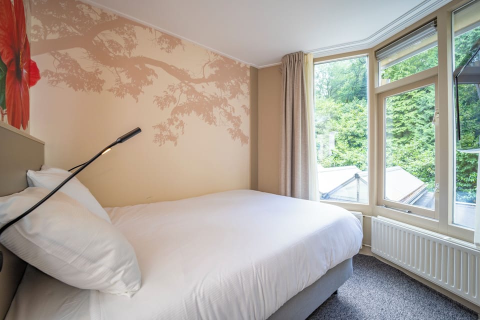Wake to soft daylight and leafy views beside you.