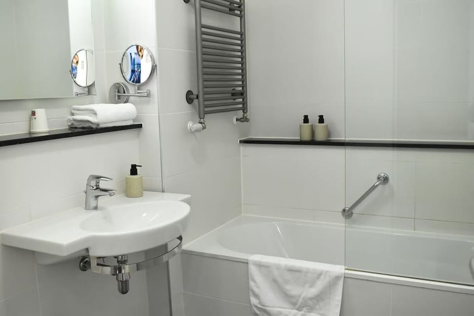 Soak and reset in a bright bath with warming towel rail.