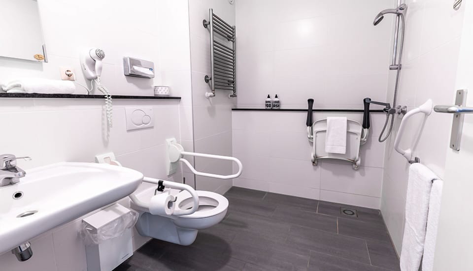 Refresh easily in an accessible bathroom with safety rails.