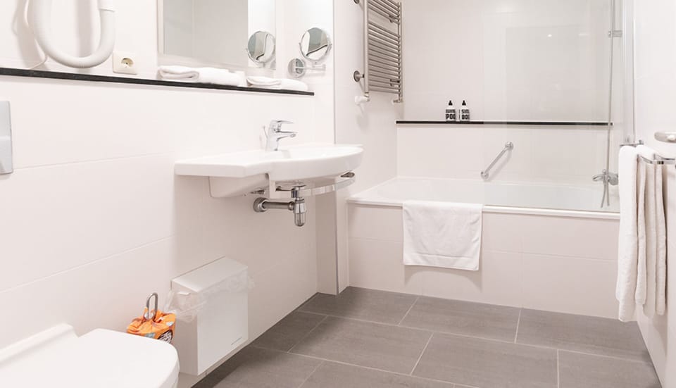 Refresh with a sparkling bath, plush towels, and bright vanity.