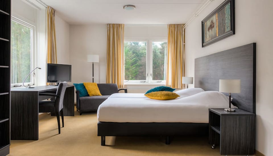 Wake up to garden views and a practical work desk.