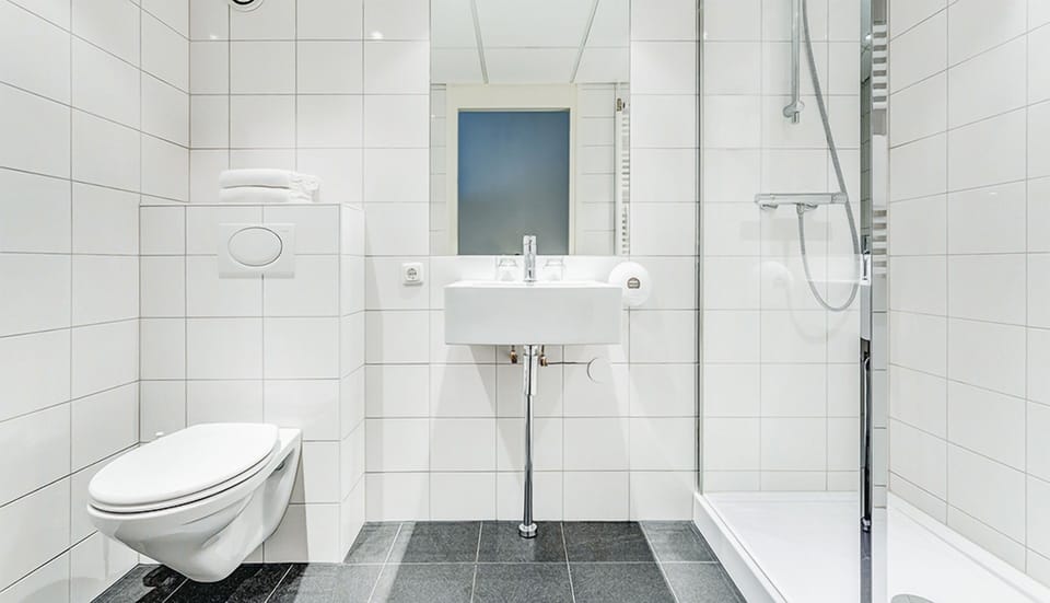 Refresh in a spotless bathroom with a bright walk-in shower.