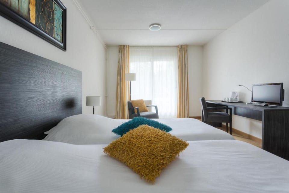 Wake up to natural light and an easy in-room workspace.