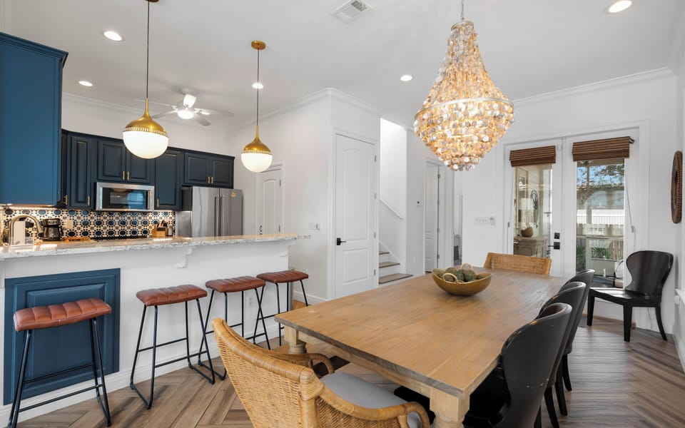 Gather around your elegant dining table under a stunning chandelier, while the open kitchen invites culinary adventures.