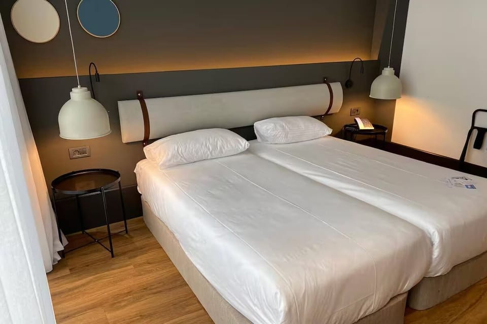 Drift into crisp linens under warm, calming bedside lighting.
