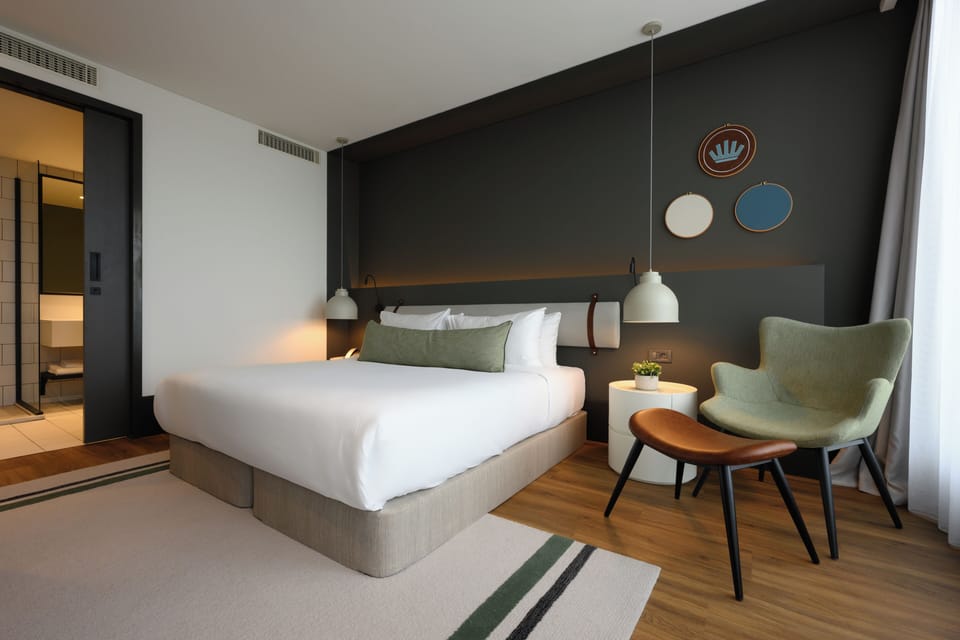 Sink into crisp linens for a serene, design-led stay.