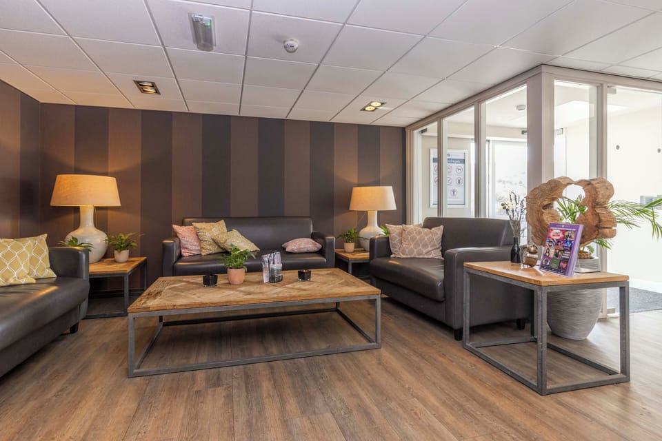 Gather comfortably for conversation in this calm, softly lit lounge.
