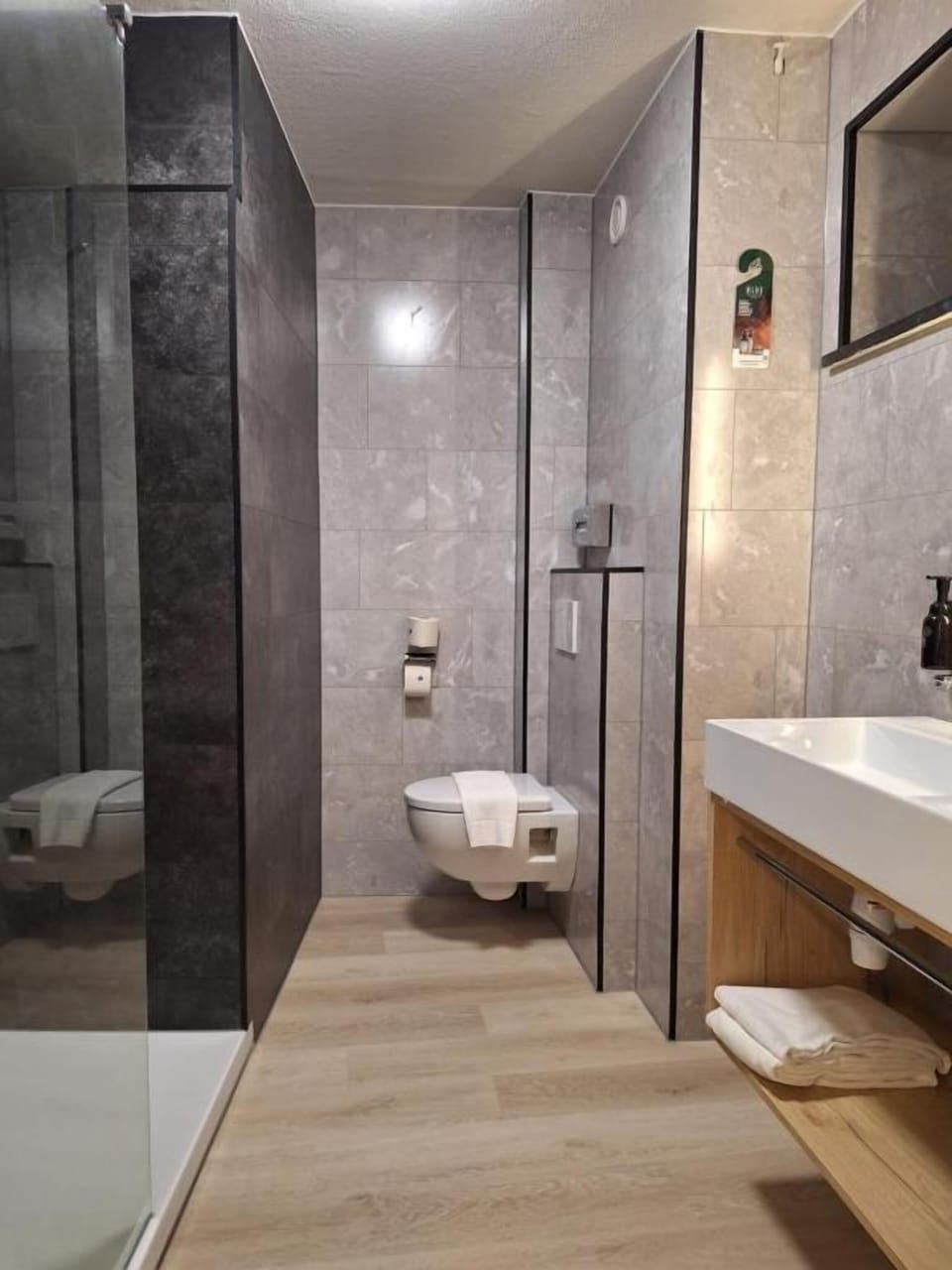 Refresh in the modern walk-in shower with plush towels ready.