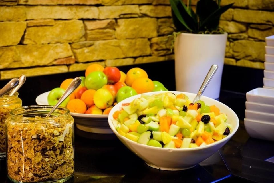 Savor colorful fresh fruit and crisp granola for breakfast.