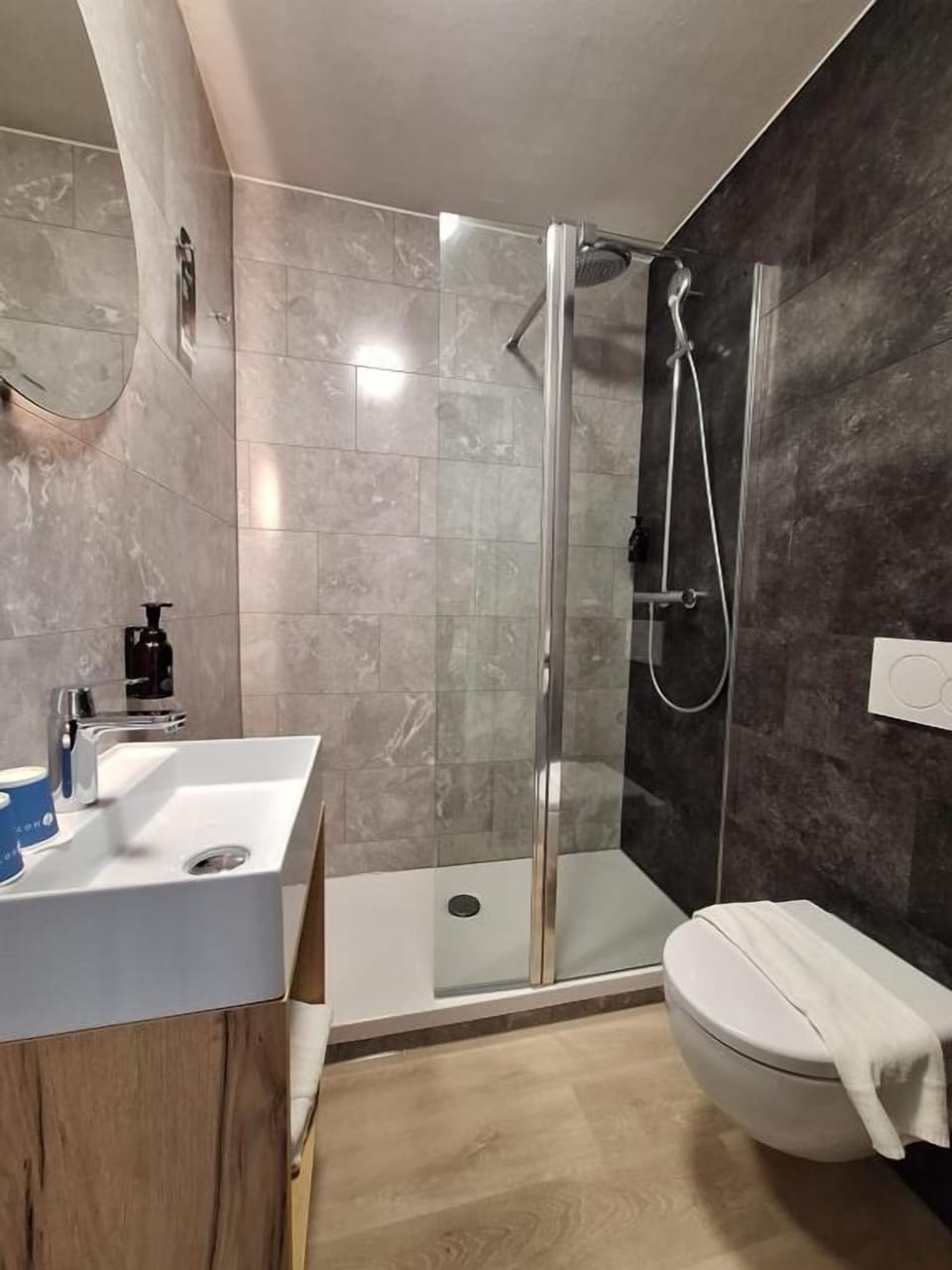 Start your morning with bright vanity lighting and a spacious shower.