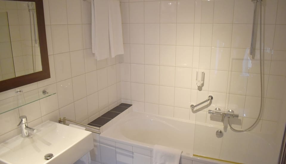 Refresh with a soothing bath in a clean, tiled bathroom.