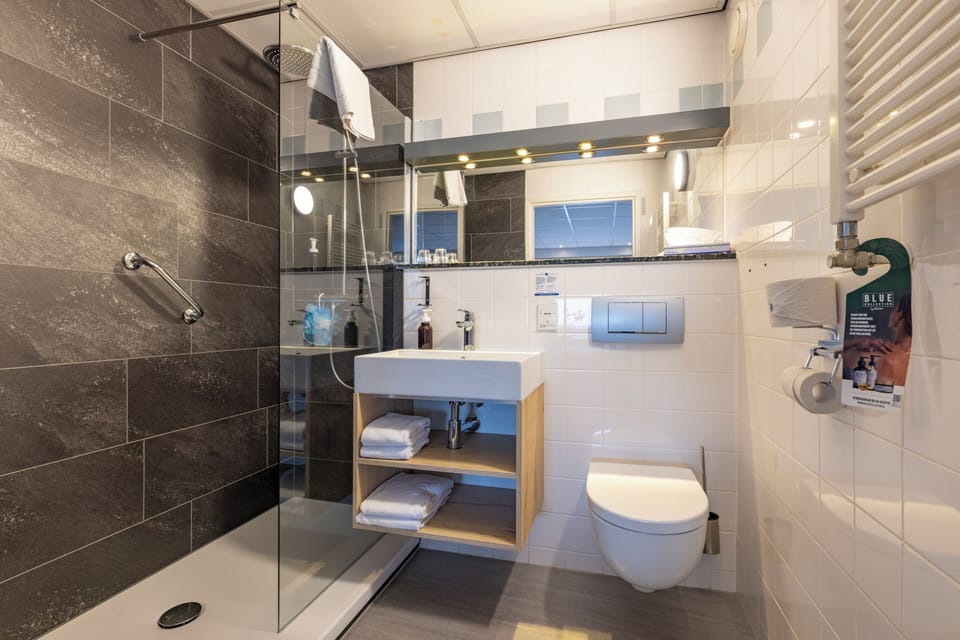Refresh under the rainfall shower in a sleek modern bathroom.