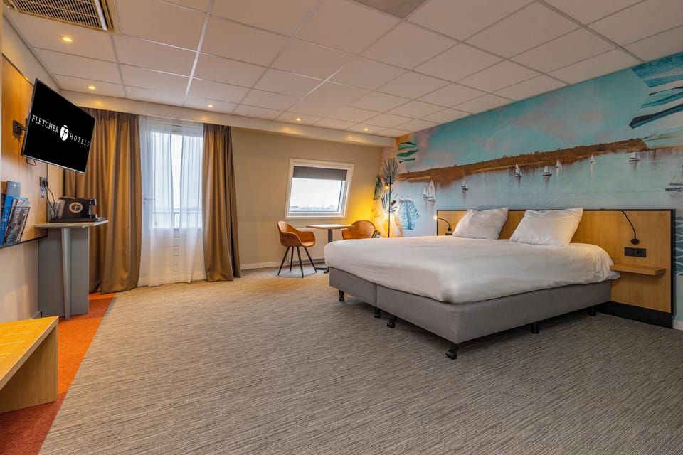 Stretch out in a spacious bedroom with warm lighting and seating.