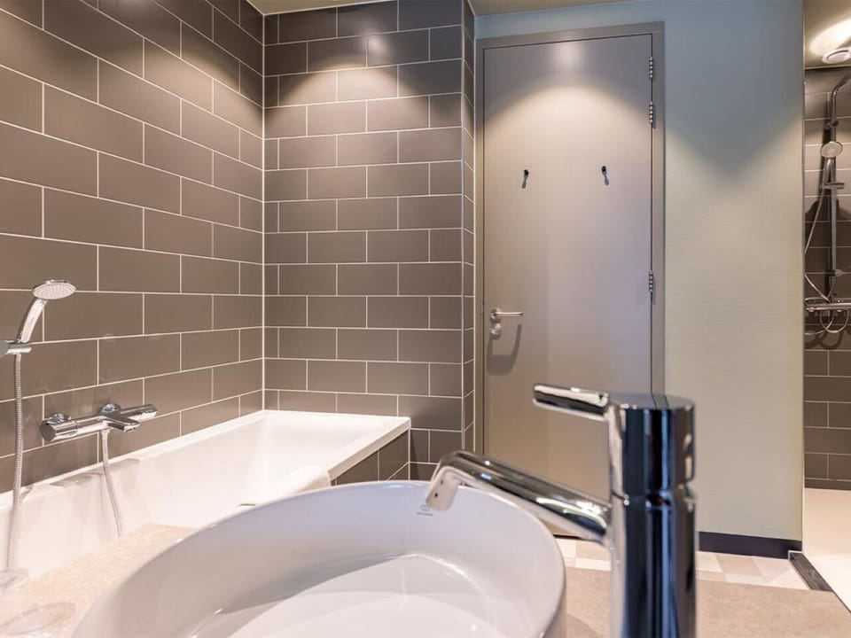 Enjoy a clean, contemporary bathroom with tub and shower.
