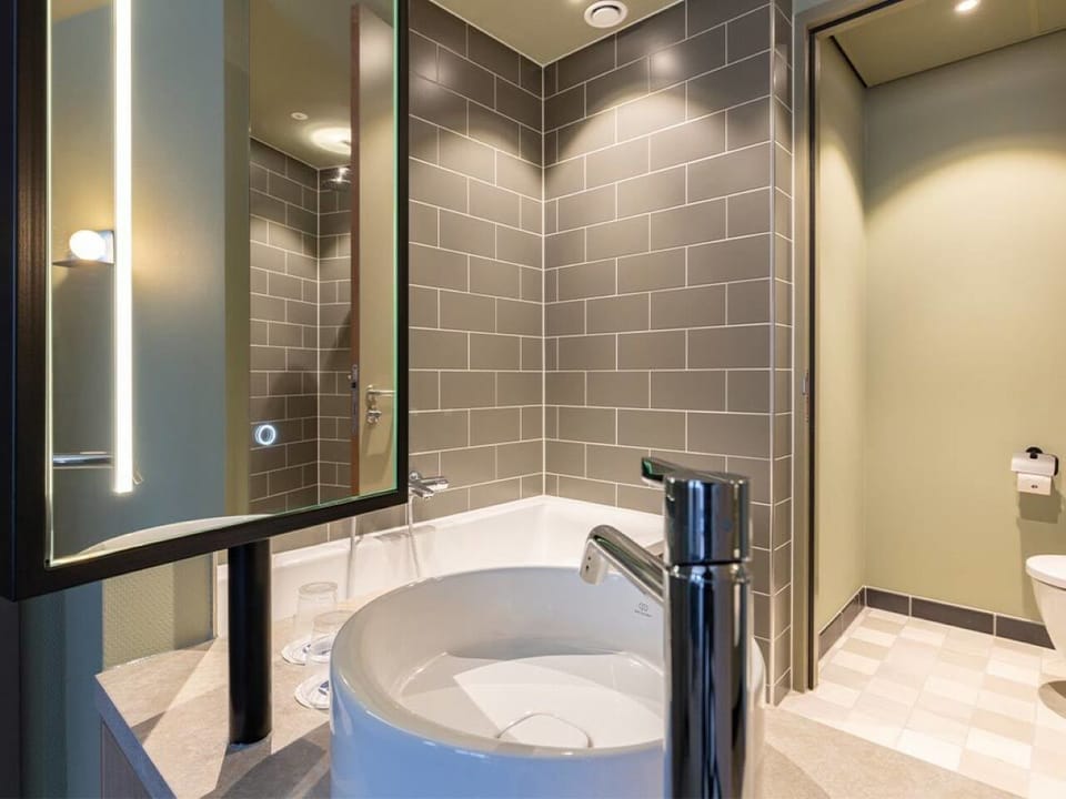Refresh effortlessly with a sleek sink and spa-like lighting.