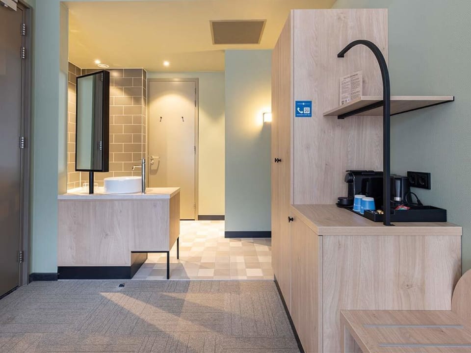 Wake up slowly with in-room coffee and tidy built-in storage.