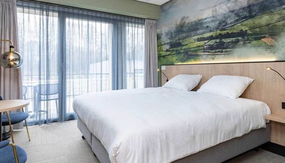 Sink into crisp linens beside panoramic windows and serene views.