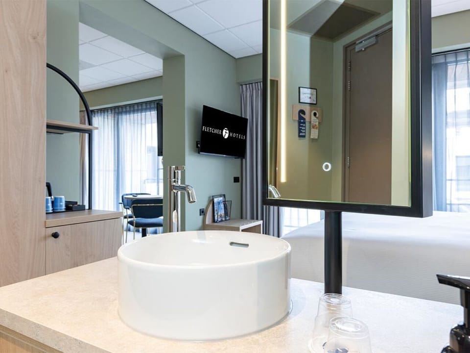 Freshen up at the sleek vanity with modern lighting.