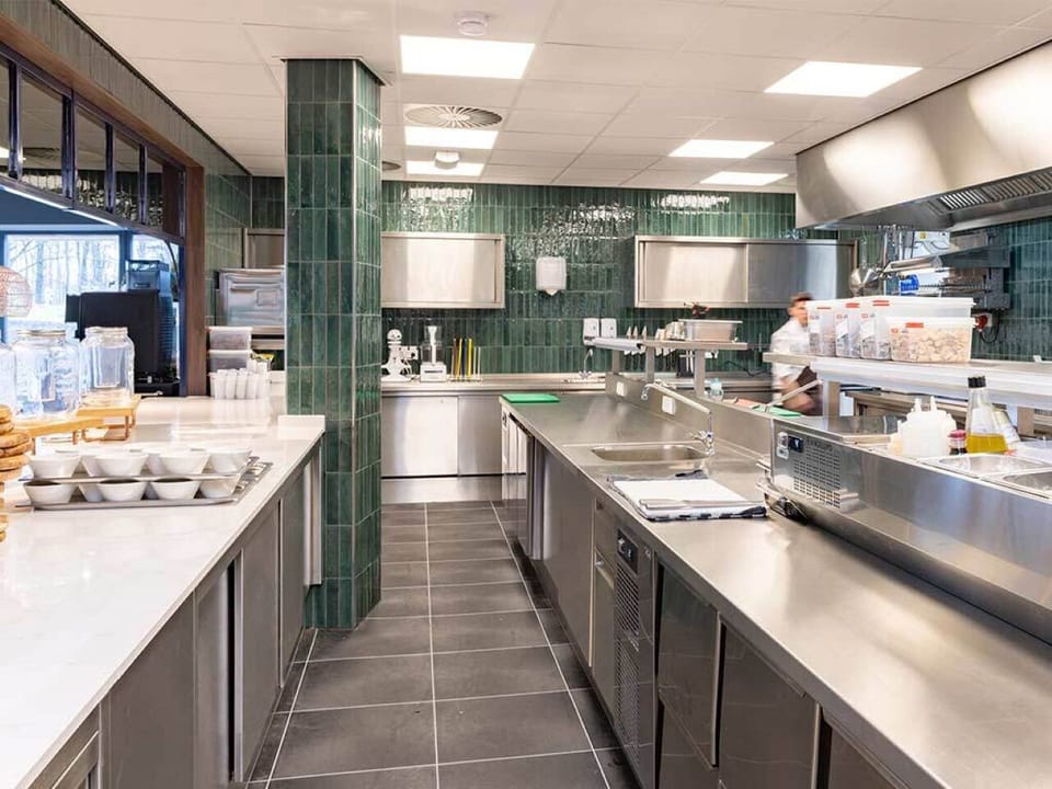 Watch chefs prep breakfast in a spotless, modern kitchen.