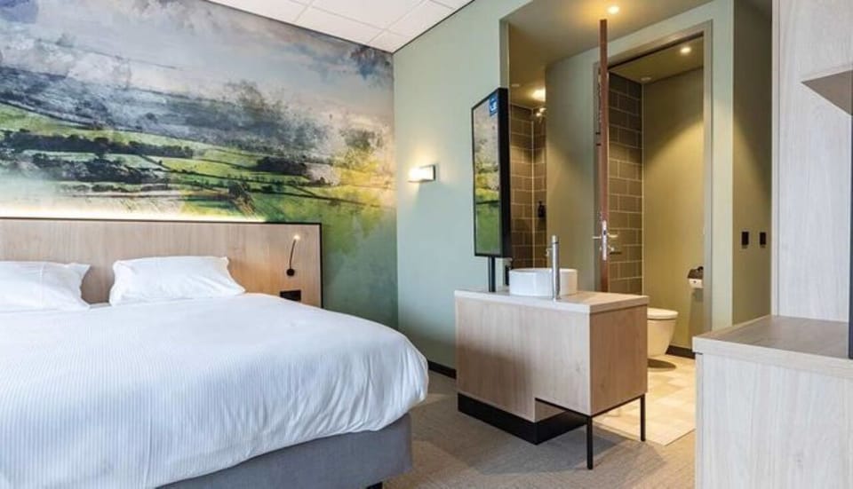Wake up in a serene bedroom with spa touches nearby.