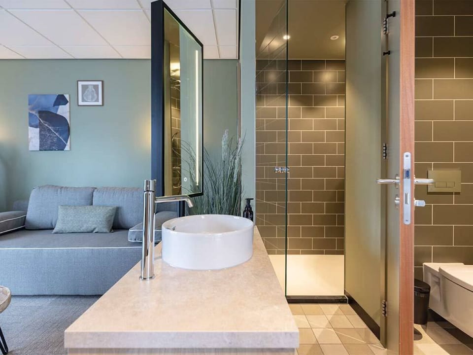 Refresh under a rainfall shower with sleek vanity comforts.