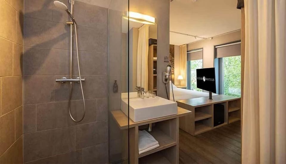 Rinse off under a rainfall shower, then glow at the vanity.