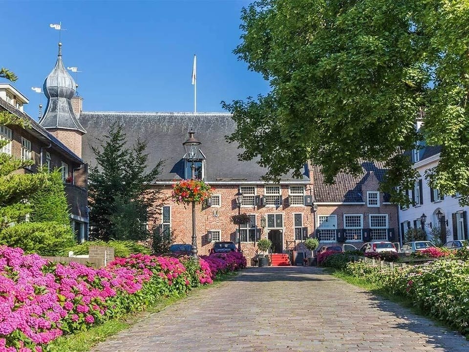 Arrive through blooming gardens to a storybook historic courtyard.