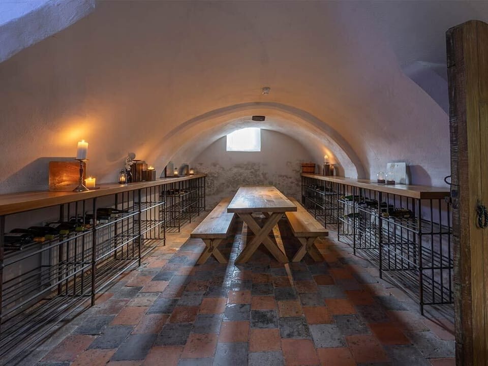 Celebrate long-table moments in a vaulted, candlelit cellar.