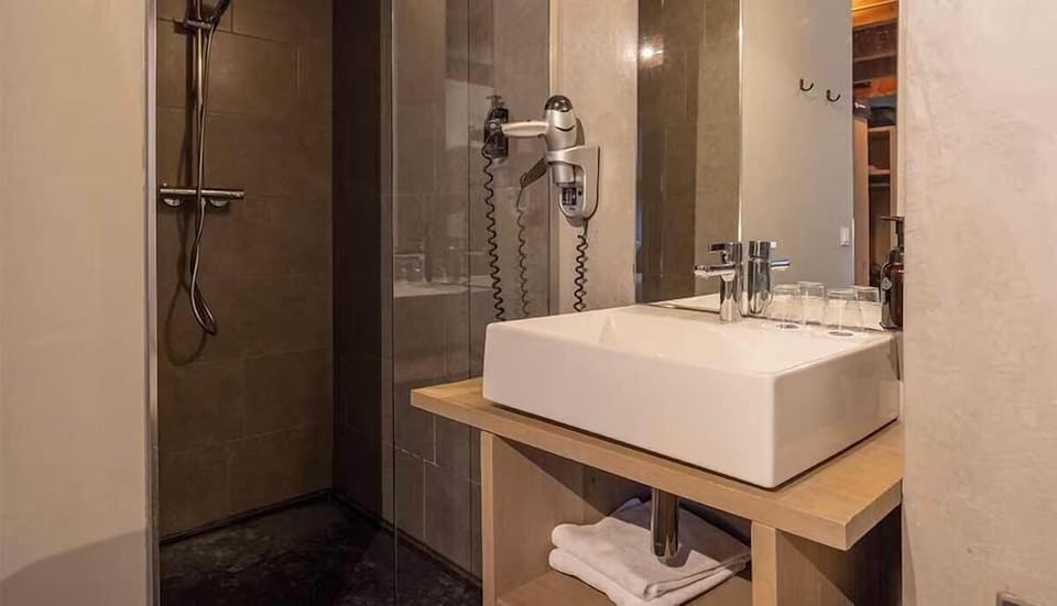 Refresh under the rainfall shower with sleek, modern vanity.