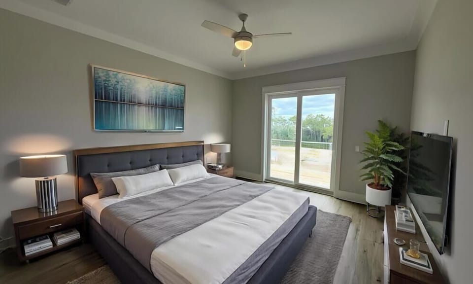 Sink into the plush comfort of your king-sized bed with crisp linens, while the ceiling fan keeps you cool. Natural light floods through sliding doors to your private balcony.