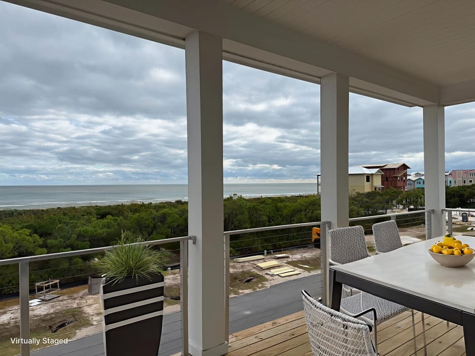 Savor morning coffee at your private dining table while ocean breezes sweep across the covered terrace, framing stunning sea views.
