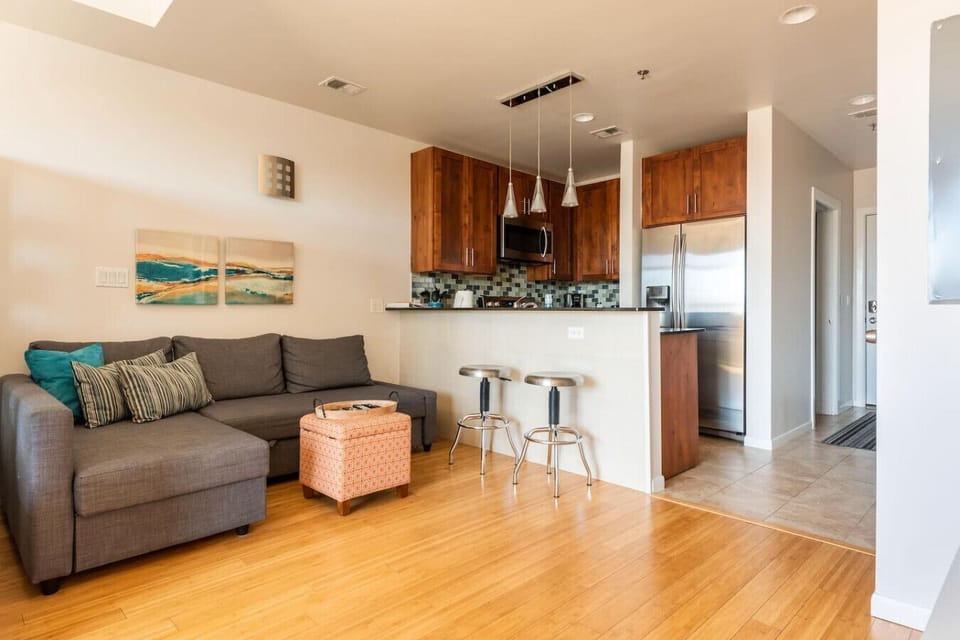 Open-concept comfort with a sleek kitchen, cozy lounge, and breakfast bar vibes.