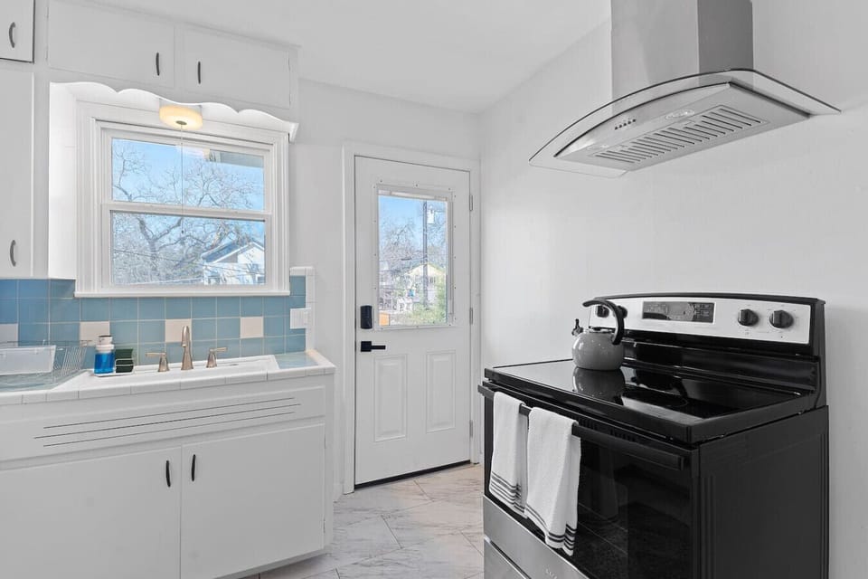 Fully equipped kitchen with modern appliances and natural light
