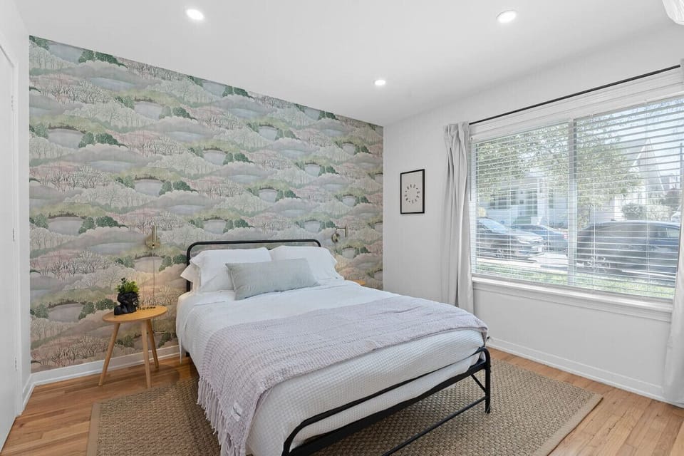 Bedroom with luxury custom hotel linens and natural light